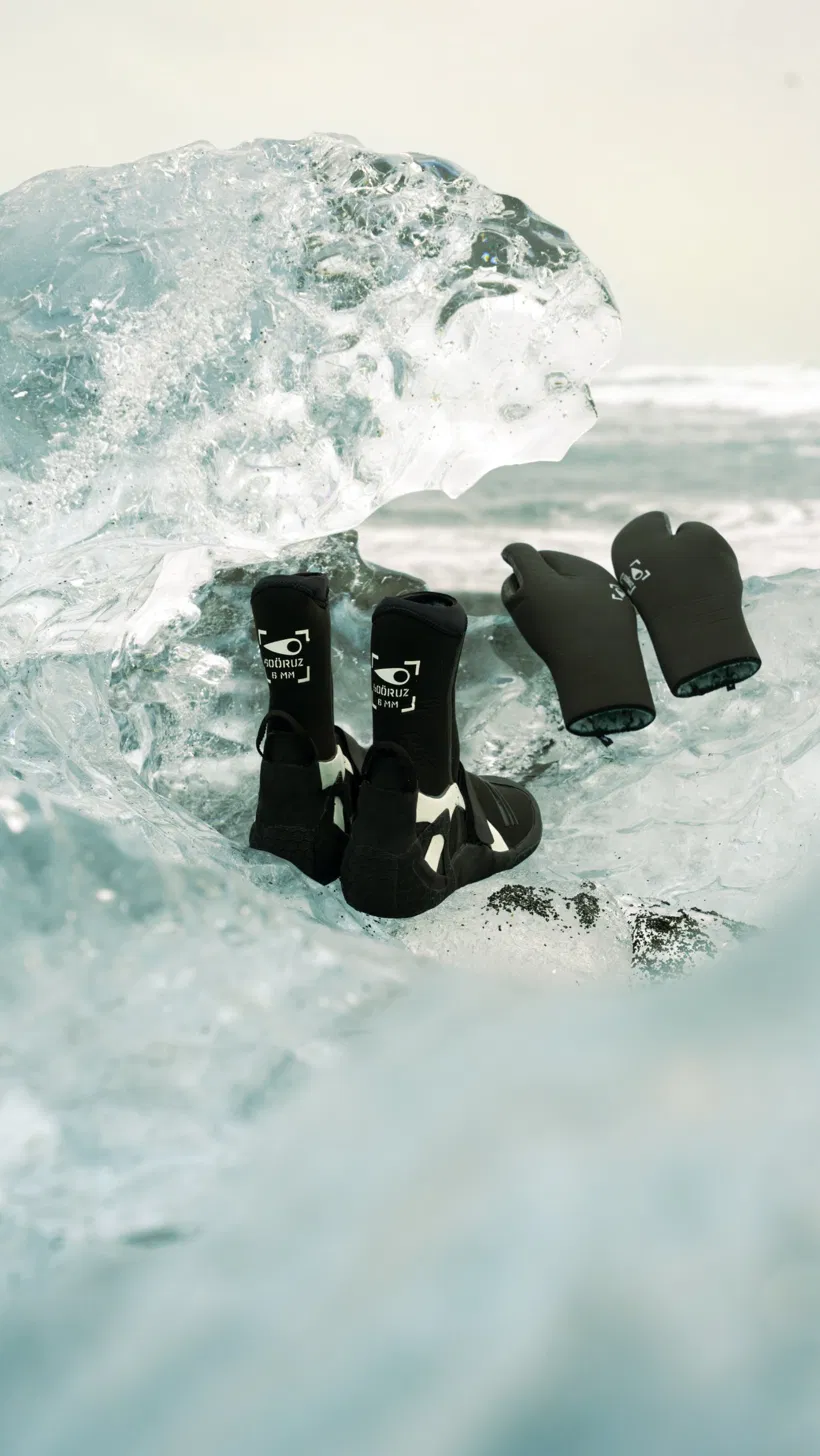 Soöruz neoprene boots and mittens resting on ice